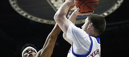 Kansas guard Sviatoslav Mykhailiuk (10) puts up a shot over UC Davis forward Chima Moneke (11) during the first half on Friday, March 17, 2017 at BOK Center in Tulsa, Oklahoma.