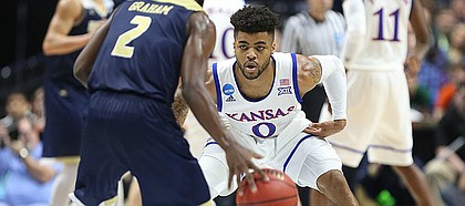 Kansas guard Frank Mason III (0) gets down on defense as UC Davis guard Darius Graham (2) brings the ball up the court during the second half on Friday, March 17, 2017 at BOK Center in Tulsa, Oklahoma.