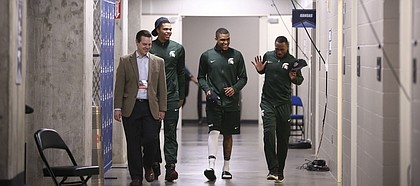 Michigan State guards Miles Bridges, second from left, Alvin Ellis III and Lourawls Nairn Jr. are escorted to interviews on Saturday, March 18, 2017 at BOK Center in Tulsa, Okla.