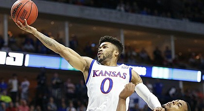 Kansas guard Frank Mason III (0) extends to the bucket past Michigan State forward Nick Ward (44) during the first half on Sunday, March 19, 2017 at BOK Center in Tulsa, Okla.