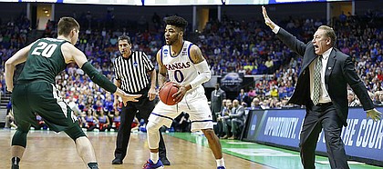 Michigan State head coach Tom Izzo directs his defense as Michigan State guard Matt McQuaid (20) guards Kansas guard Frank Mason III (0) during the first half on Sunday, March 19, 2017 at BOK Center in Tulsa, Okla.