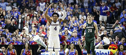 Kansas guard Devonte' Graham (4) raises up the KU fanbase during a run by the Jayhawks in the first half on Sunday, March 19, 2017 at BOK Center in Tulsa, Okla. At right is Michigan State guard Matt McQuaid (20).