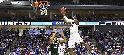 Kansas guard Josh Jackson (11) floats in for a bucket over Michigan State forward Kenny Goins (25) during the second half on Sunday, March 19, 2017 at BOK Center in Tulsa, Okla.