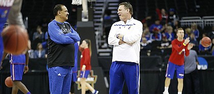 Kansas head coach Bill Self, right, and assistant Kurtis Townsend chat at half court during a day of practices and press conferences prior to a March 2017 KU game at Sprint Center in Kansas City, Mo.