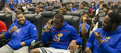 Kansas defensive end Dorance Armstrong Jr., front and center, gets a call from co-defensive coordinator and cornerbacks coach Kenny Perry notifying him that Perry had selected Armstrong as the second overall pick during a spring game player draft on Wednesday, April 12, 2017 at the Anderson Family Football Complex.
