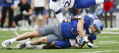 Team KU wide receiver Chase Harrell (3) takes Team Jayhawks safety Emmanuel Moore (20) off of his feet after a catch during the first quarter of the 2017 Spring Game on Saturday, April 15 at Memorial Stadium.