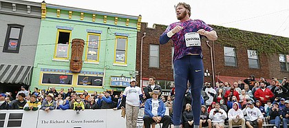 Reigning Olympic gold medalist and winner of the Downtown Shot Put Ryan Crouser jumps in the ring as he watches his final throw on Friday, April 21, 2017 at the intersection of Eighth and New Hampshire streets.