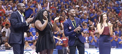 Kansas track and field coach Stanley Redwine, left, stands with 2016 Olympic athletes Daina Levy, Kyle Clemons and Andrea Geubelle as they are honored before the Fieldhouse during Late Night in the Phog on Saturday, Oct. 1, 2016.