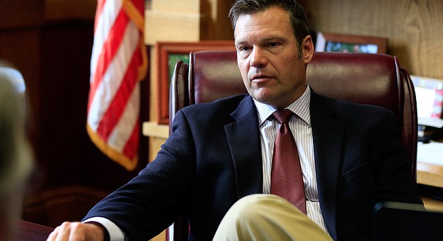 In this Wednesday, May 17, 2017 photo, Kansas Secretary of State Kris Kobach talks with a reporter in his office in Topeka, Kan. (AP Photo/Orlin Wagner)