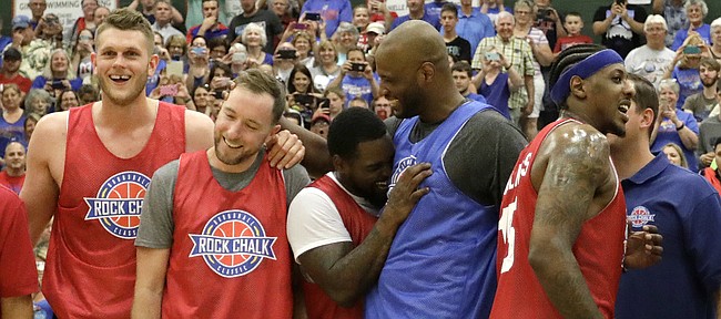 Members of the 2008 championship team gather at half court during the 2017 Rock Chalk Roundball Classic Thursday evening at Lawrence Free State High School. The annual charity event benefits local families fighting cancer