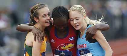 San Francisco's Charlotte Taylor, left, Kansas' Sharon Lokedi, center, and New Mexico's Alice Wright, right, embrace after finishing the women's 10,000 meters on the second day of the NCAA outdoor college track and field championships in Eugene, Ore., Thursday, June 8, 2017. Taylor won the race in 32 minutes, 38.57 seconds. (AP Photo/Timothy J. Gonzalez)