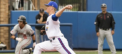 Kansas sophomore pitcher Blake Weiman sends a pitch to the plate while Texas Tech senior Tyler Neslony takes a lead off of third base during the final game of their series Sunday morning at Hoglund Ballpark.
