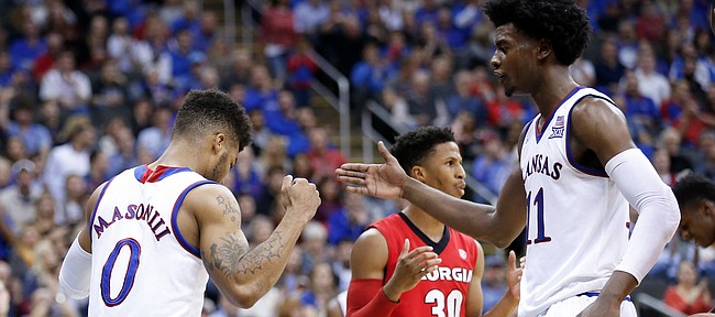 Kansas guard Frank Mason III (0) slaps hands with Kansas guard Josh Jackson (11) after getting a bucket and a foul during the second half, Tuesday, Nov. 22, 2016 during the championship game of the CBE Classic at Sprint Center.