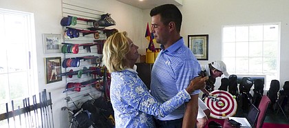 Linda Randall, wife of late Kansas golf coach Ross Randall, congratulates PGA touring pro Gary Woodland on the birth of his and wife Gabby's first child. They were at Twin Oaks in Eudora for the Ross Randall Par 3 Shootout.