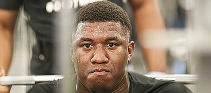Sweat pours from the face of Kansas defensive tackle Daniel Wise as he prepares for a squat at the Anderson Family Football Complex on Thursday, June 29, 2017.