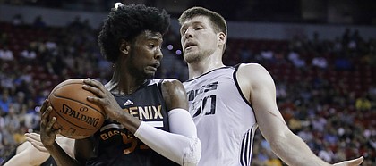Phoenix Suns' Josh Jackson grabs a rebound next to Sacramento Kings' Jack Cooley during the first half of an NBA summer league basketball game, Friday, July 7, 2017, in Las Vegas.
