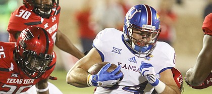 Kansas tight end Ben Johnson (84) is brought down after a catch during the first quarter on Thursday, Sept. 29, 2016 at Jones AT&T Stadium in Lubbock, Texas.