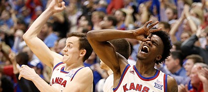 Kansas guard Lagerald Vick (2) and Kansas forward Mitch Lightfoot (44) celebrate a late, second-half three by Kansas guard Devonte' Graham (4), Monday, Feb. 13, 2017 at Allen Fieldhouse.