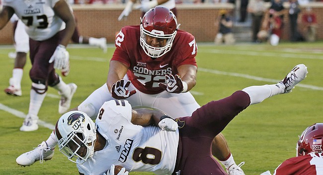 Louisiana Monroe wide receiver De'Vonte Haggerty (8) is brought down by Oklahoma defensive end Amani Bledsoe (72) and linebacker Caleb Kelly (19) during an NCAA college football game between Louisiana Monroe and Oklahoma in Norman, Okla., Saturday, Sept. 10, 2016. (AP Photo/Sue Ogrocki)