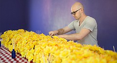 Artist Anson DeOrnery, who goes by the artist name Anson the Ornery, arranges daffodils for his installation Deluge, which runs through Sept. 9 at the Lawrence Arts Center, 940 New Hampshire St.
