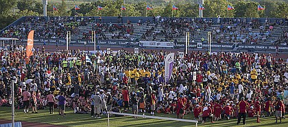 Track and field athletes stop in the infield during the USATF National Junior Olympics opening ceremony on Tuesday, July 25, 2017. More than 8,000 athletes attended the Junior Olympics at Rock Chalk Park.