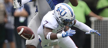Kansas cornerback Derrick Neal (7) disrupts a pass to Memphis wide receiver Phil Mayhue (89) during the first quarter on Saturday, Sept. 17, 2016 at Liberty Bowl Memorial Stadium in Memphis, Tenn.