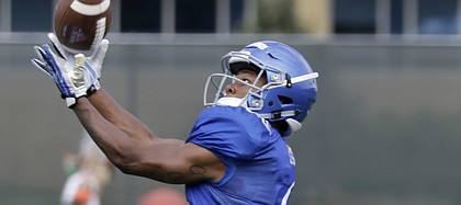 Kansas freshman receiver Quan Hampton reaches out for a catch during preseason practice on Monday, Aug. 7, 2017.