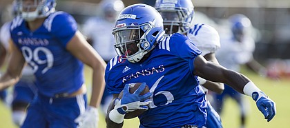 Kansas kick returner Deron Thompson runs up the sidelines during practice on Friday, Aug. 11, 2017 at the practice fields west of Hoglund Ballpark.