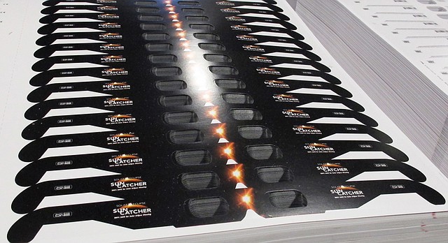 Cardboard frames for solar eclipse glasses are stacked in the American Paper Optics factory in Bartlett, Tenn., on Wednesday, June 21, 2017. (AP Photo/Adrian Sainz)