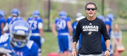 Kansas offensive coordinator and receivers coach Doug Meacham watches over a drill during practice on Monday, Aug. 14, 2017 at the grass fields adjacent to Hoglund Ballpark.
