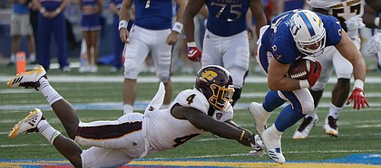 Kansas tight end Ben Johnson slips past a CMU defender during the Jayhawks game against Central Michigan Saturday, Sept. 9 at Memorial Stadium.