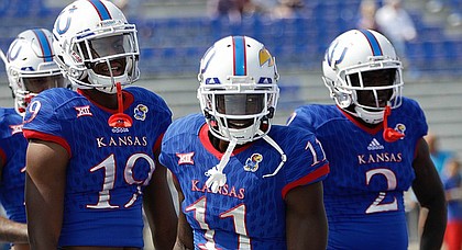 Kansas junior receiver Steven Sims Jr., center, cracks a smile in pre-game warmups prior to Saturday's game against Central Michigan at Memorial Stadium.