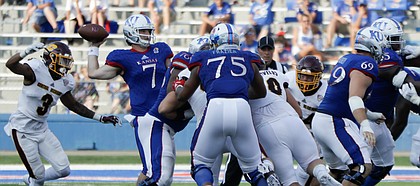 Kansas quarterback Peyton Bender (7) passes while under pressure from the CMU defense during the Jayhawks game against Central Michigan Saturday, Sept. 9 at Memorial Stadium.