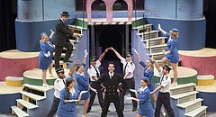 Above: The cast of Theatre Lawrence's “Catch Me If You Can” gathers around Alex Castaneda, who plays prolific con artist Frank Abagnale Jr.