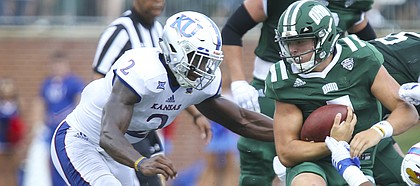 Kansas defensive end Dorance Armstrong Jr. (2) and Kansas defensive tackle Kellen Ash (97) bring down Ohio quarterback Quinton Maxwell (7) during the second quarter on Saturday, Sept. 16, 2017 at Peden Stadium in Athens, Ohio.