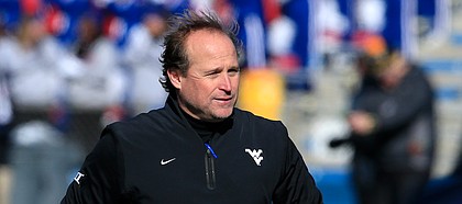 West Virginia football coach Dana Holgorsen walks the sidelines during the first half of his team's last trip to Memorial Stadium on Saturday, Nov. 21, 2015. The Mountaineers defeated the Jayhawks 49-0 that day to move to 1-1 all-time in Lawrence.