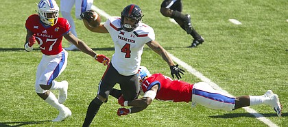 Texas Tech running back Justin Stockton (4) is tackled by Kansas safety Mike Lee (11) during the half on Saturday, Oct. 7, 2017 at Memorial Stadium.