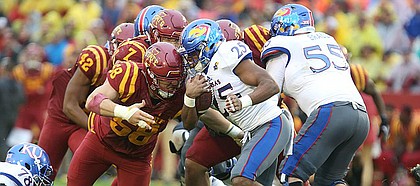 Kansas running back Dom Williams (25) is hit by Iowa State defensive end J.D. Waggoner (58) on a run during the second quarter on Saturday, Oct. 14, 2017 at Jack Trice Stadium in Ames, Iowa.