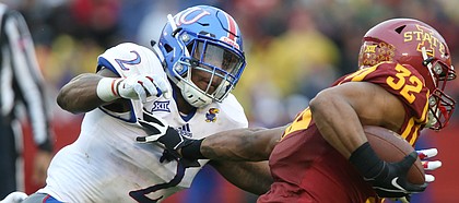 Kansas defensive end Dorance Armstrong Jr. (2) comes in to wrap up Iowa State running back David Montgomery (32) during the first quarter on Saturday, Oct. 14, 2017 at Jack Trice Stadium in Ames, Iowa.