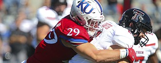 Kansas linebacker Joe Dineen Jr. (29) stops Texas Tech quarterback McLane Carter (6) on a run during the fourth quarter on Saturday, Oct. 7, 2017 at Memorial Stadium.