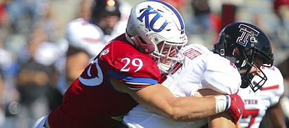Kansas linebacker Joe Dineen Jr. (29) stops Texas Tech quarterback McLane Carter (6) on a run during the fourth quarter on Saturday, Oct. 7, 2017 at Memorial Stadium.