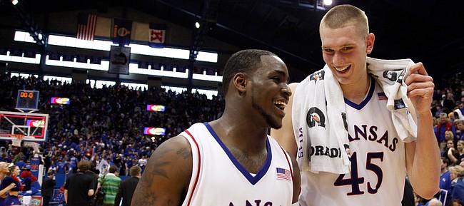 Kansas teammates Sherron Collins, front, and Cole Aldrich are all smiles leaving the court following the Jayhawks' win over Missouri Sunday, March 1, 2009 at Allen Fieldhouse.