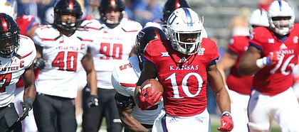 Kansas running back Khalil Herbert (10) charges up the field to set up a touchdown for the Jayhawks during the third quarter on Saturday, Oct. 7, 2017 at Memorial Stadium.