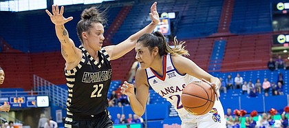 Kansas junior guard Brianna Osorio (2) tries to drive past Emporia State defender Jacee Kramer (22) in the first quarter of Sunday's exhibition game at Allen Fieldhouse.