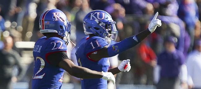 Kansas safety Mike Lee (11) celebrates with Kansas safety Tyrone Miller Jr. (22) after stopping Kansas State on a fourth and 1 during the first quarter on Saturday, Oct. 28, 2017 at Memorial Stadium.