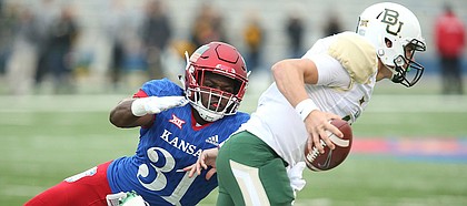 Kansas linebacker Osaze Ogbebor (31) stops Baylor Bears quarterback Zach Smith (11) on a third down during the first quarter on Saturday, Sept. 4, 2017 at Memorial Stadium.