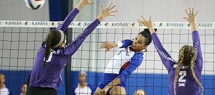 Kansas middle blocker Zoe Hill (6) sends a shot between Kansas State middle blocker Peyton Williams (11) and Kansas State middle blocker Elle Sandbothe (2) during the second set on Wednesday, Nov. 8, 2017.
