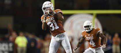 Texas linebacker Kyle Hrncir (31) intercepts a pass by Kansas quarterback Carter Stanley (9), not in the picture, during an NCAA football game, Saturday, Nov. 11, 2017 in Austin, Texas. (TFV Media via AP)