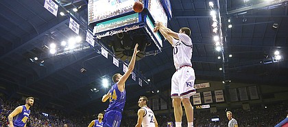 Kansas guard Sviatoslav Mykhailiuk (10) puts up a three from the corner over South Dakota State forward Mike Daum (24) with seconds remaining in the first half on Friday, Nov. 17, 2017 at Allen Fieldhouse.