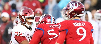 Oklahoma defensive lineman Amani Bledsoe (72) wrestles with Kansas offensive lineman Zach Hannon (56) during the third quarter on Saturday, Nov. 18, 2017 at Memorial Stadium.